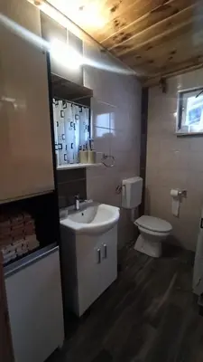a bathroom with a sink and a toilet at Cute lodge in Zeta in Mahala
