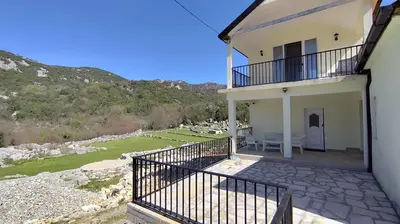 a house with a balcony with a view of a yard at Bobija Village Skadar lake in Karuč