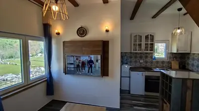 a kitchen with a picture hanging on the wall at Bobija Village Skadar lake in Karuč