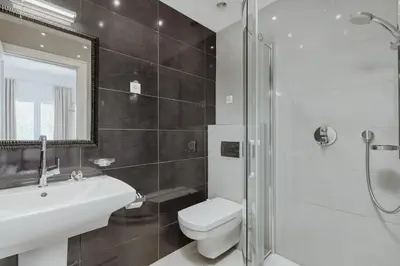 a bathroom with a toilet and a sink and a shower at Vila Bellevue in Budva