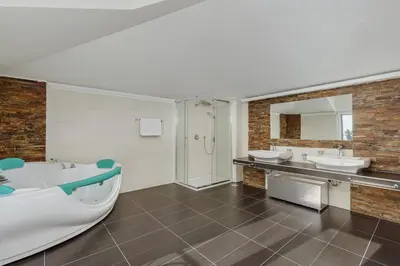 a bathroom with two sinks and a tub and a shower at Vila Bellevue in Budva
