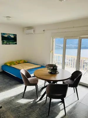 a room with a table and chairs and a bed at TOP view Apartment Budva in Budva