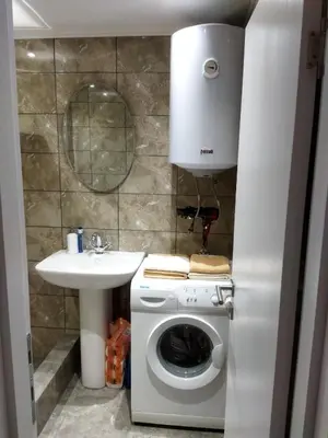 a bathroom with a washing machine and a sink at TOP view Apartment Budva in Budva