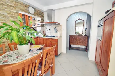 a kitchen with a table with a plant on it at Apartment OAZA in Kotor