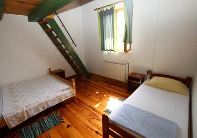 a small room with two beds and a staircase at STONE HOUSE “MEDITERRANEO” in Bar