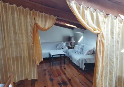 a living room with a bed and curtains at STONE HOUSE “MEDITERRANEO” in Bar