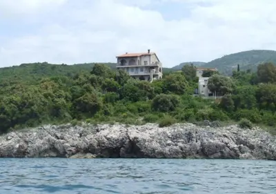a house sitting on top of a hill next to the water at STONE HOUSE “MEDITERRANEO” in Bar