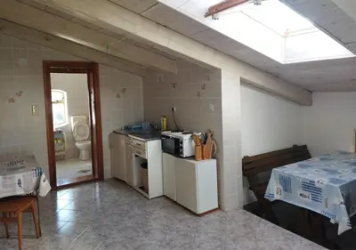 a small kitchen with a stove and a microwave at STONE HOUSE “MEDITERRANEO” in Bar