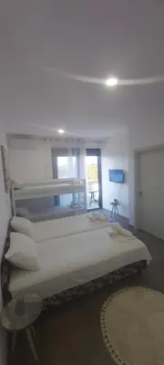 a room with four beds in a room at Apartament Mehmeti in Ulcinj