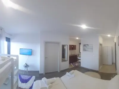 a living room with white walls and white furniture at Apartament Mehmeti in Ulcinj