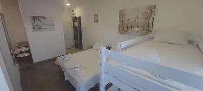 a white room with two beds and a mirror at Apartament Mehmeti in Ulcinj