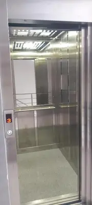an elevator door with a window in a building at Apartament Mehmeti in Ulcinj