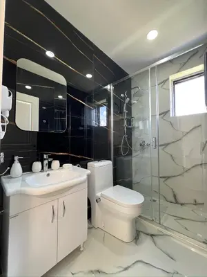 a bathroom with a toilet and a sink and a shower at Apartments Bojku in Ulcinj