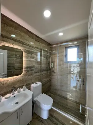 a bathroom with a toilet and a sink and a shower at Apartments Bojku in Ulcinj