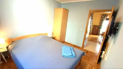 a bedroom with a bed with a blue towel on it at Nossa Casa in Becici