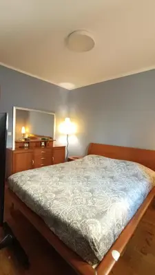 a bedroom with a bed and a dresser and a mirror at Nossa Casa in Becici