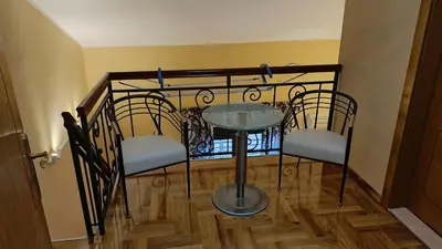 a table and chairs in a room with a staircase at Nossa Casa in Becici