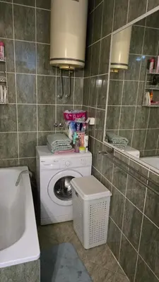 a bathroom with a washing machine and a washer at Sophie's Emerald Studio apartment in Podgorica