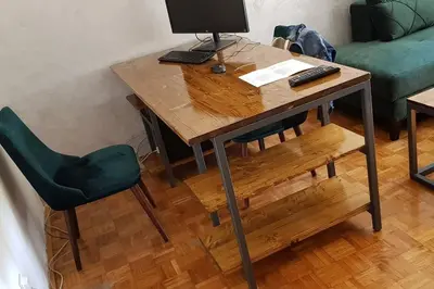 a wooden table with a computer on top of it at Sophie's Emerald Studio apartment in Podgorica