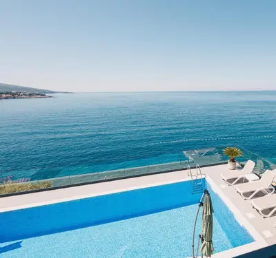 a swimming pool with a view of the ocean at Orange Villa - 7 Bedrooms - 5 Star Location - Views - Pool in Dobra Voda