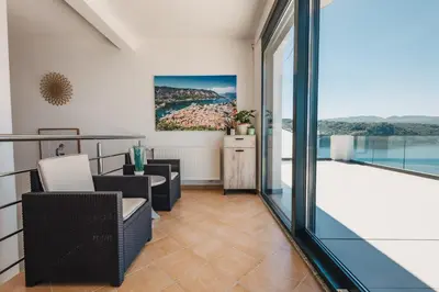 a balcony with a view of the water at Orange Villa - 7 Bedrooms - 5 Star Location - Views - Pool in Dobra Voda
