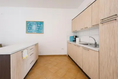 a kitchen with wooden cabinets and a sink at Orange Villa - 7 Bedrooms - 5 Star Location - Views - Pool in Dobra Voda