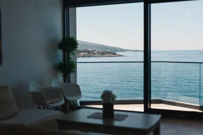 a living room with a view of the ocean at Orange Villa - 7 Bedrooms - 5 Star Location - Views - Pool in Dobra Voda