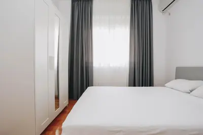 a bedroom with a white bed and a window at Status-M Apartments Sunny Side in Becici