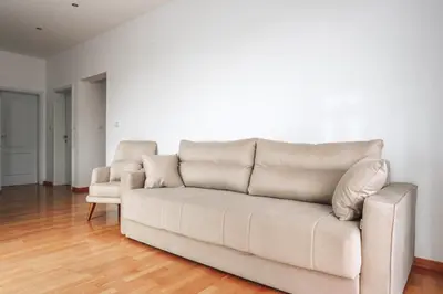 a couch and a chair in a living room at Status-M Apartments Sunny Side in Becici