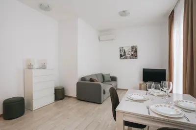 a white living room with a table and a couch at Status-M Apartments Przno in Pržno