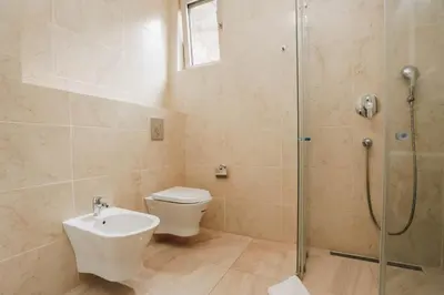 a bathroom with a shower and a toilet and a sink at Status-M Apartments Przno in Pržno