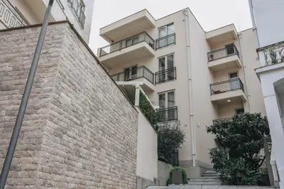 an apartment building with balconies and a brick wall at Status-M Apartments Przno in Pržno