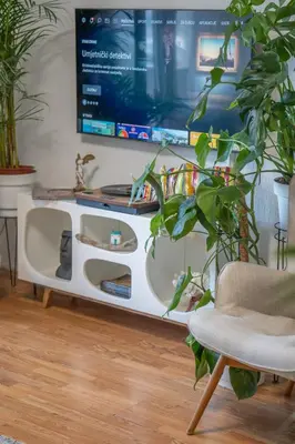 a living room with a tv on a white entertainment center at The view of Kotor - Sea & Old town view in Kotor