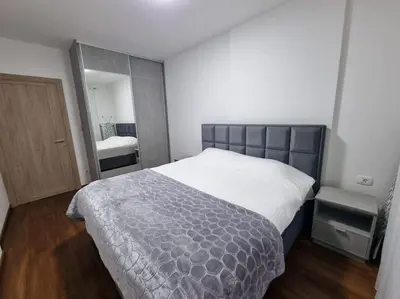 a bedroom with a large bed and a mirror at Master Quart modern apt. 27 in Podgorica