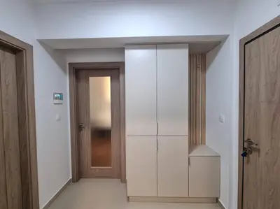 a hallway with a white closet and a door at Master Quart modern apt. 27 in Podgorica