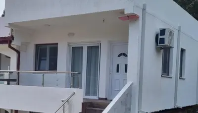 a white house with a door and a balcony at Apartment AS in Čanj
