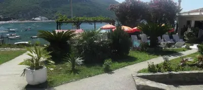 a resort with chairs and umbrellas and a body of water at Apartment AS in Čanj