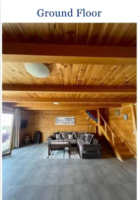 a living room with a couch and a staircase at Krnic Kottage Ratac-Sutomore-Bar-Montenegro in Sutomore