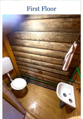 a first floor bathroom with a toilet and a sink at Krnic Kottage Ratac-Sutomore-Bar-Montenegro in Sutomore