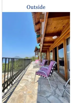 a deck with purple chairs on a house at Krnic Kottage Ratac-Sutomore-Bar-Montenegro in Sutomore