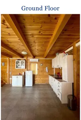 a large kitchen with white appliances and wooden ceilings at Krnic Kottage Ratac-Sutomore-Bar-Montenegro in Sutomore