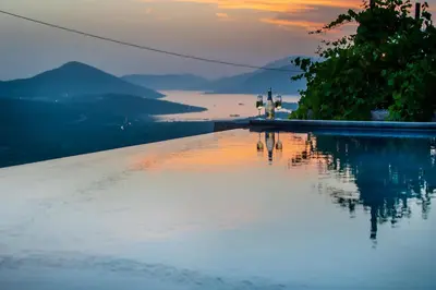 a swimming pool with a view of the water at Villa Di Campagna in Kotor
