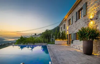 a house with a swimming pool next to a building at Villa Di Campagna in Kotor