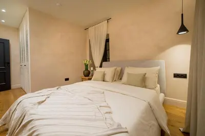 a bedroom with a large bed with white sheets and pillows at Villa Di Campagna in Kotor