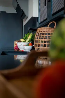 a counter top with bowls of vegetables and a basket at Villa Di Campagna in Kotor