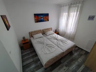 a bedroom with a bed and a window at Apollon home apartments in Bar