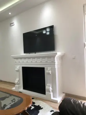 a living room with a fireplace with a tv on top of it at Apartments Long Beach in Ulcinj