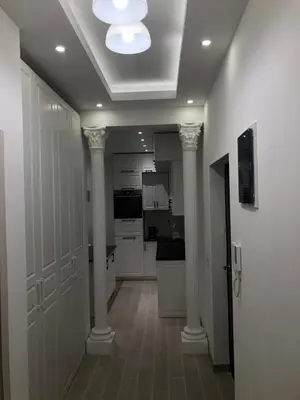 a kitchen with white walls and columns and a ceiling at Apartments Long Beach in Ulcinj