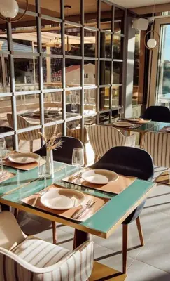 a dining room with a table and chairs at Status-M Apartments 100 in Becici