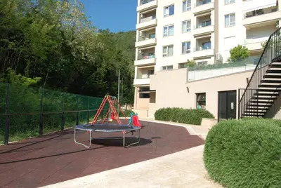 a trampoline on a patio in front of a building at Status-M Apartments 100 in Becici